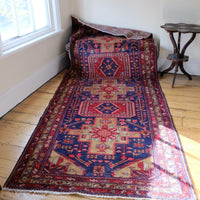 A vintage Kordi handmade wool rug runner with a geometric pattern primarily in blue and red colors.