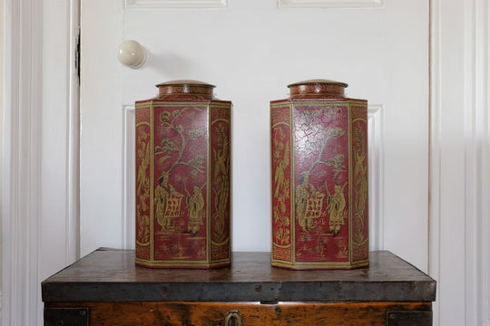 Pair of octagonal shaped Toleware canisters with gilded chinoiserie