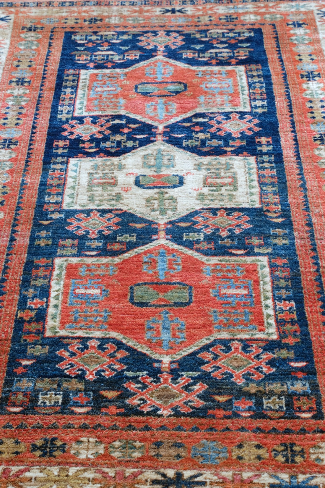 Caucasus Kazak wool rug with shield kazak medallions
