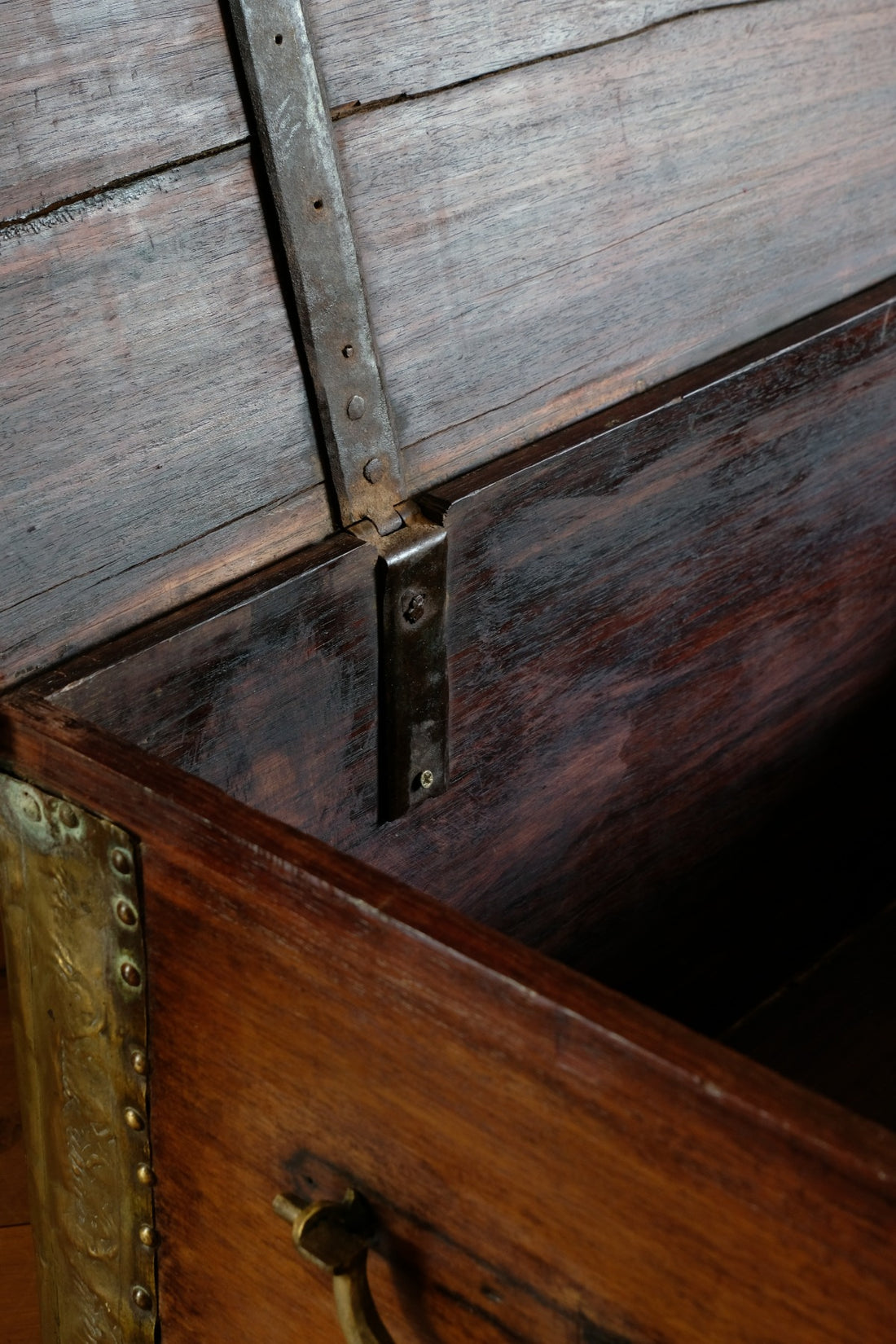 Teak Zanzibar chest decorated with brass studs raised on bun feet