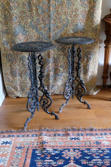Pair of ornate cast iron tripod tables for the garden or indoors