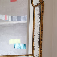 Large antique arched sectional giltwood foxed mirror circa 1910