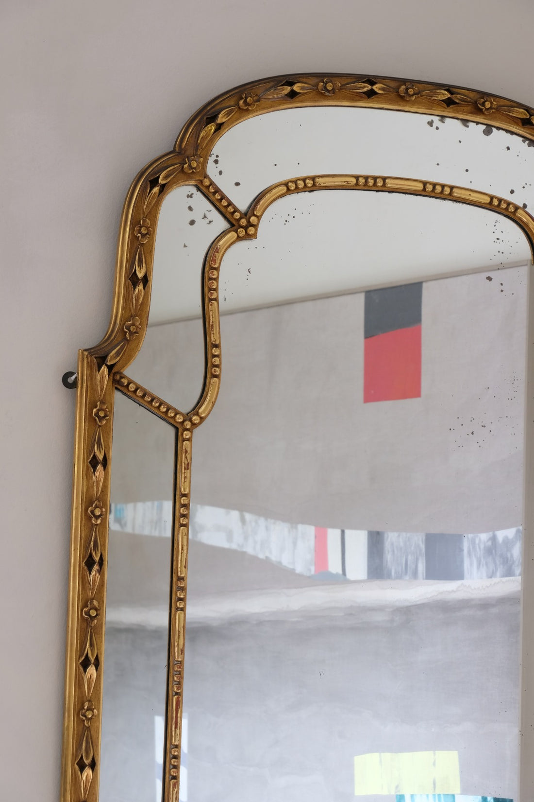 Large antique arched sectional giltwood foxed mirror circa 1910
