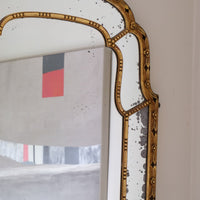 Large antique arched sectional giltwood foxed mirror circa 1910