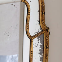 Large antique arched sectional giltwood foxed mirror circa 1910