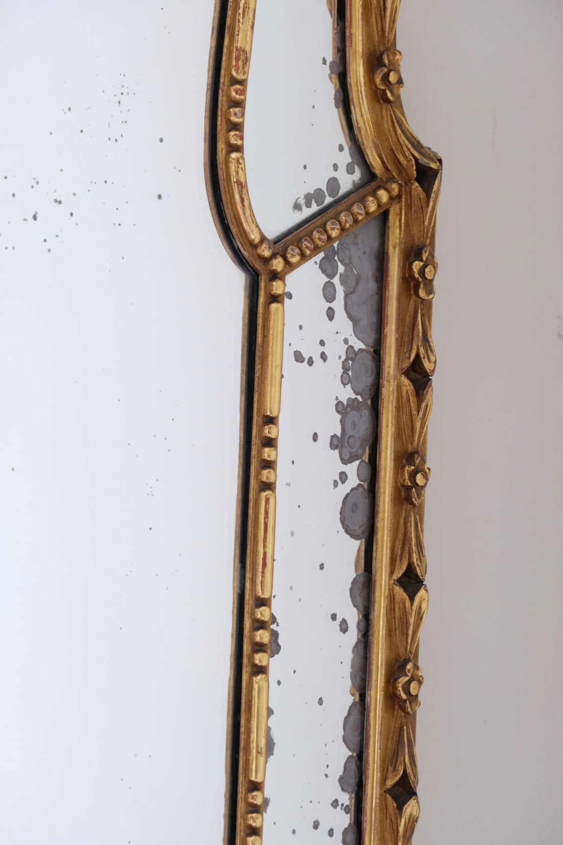 Large antique arched sectional giltwood foxed mirror circa 1910