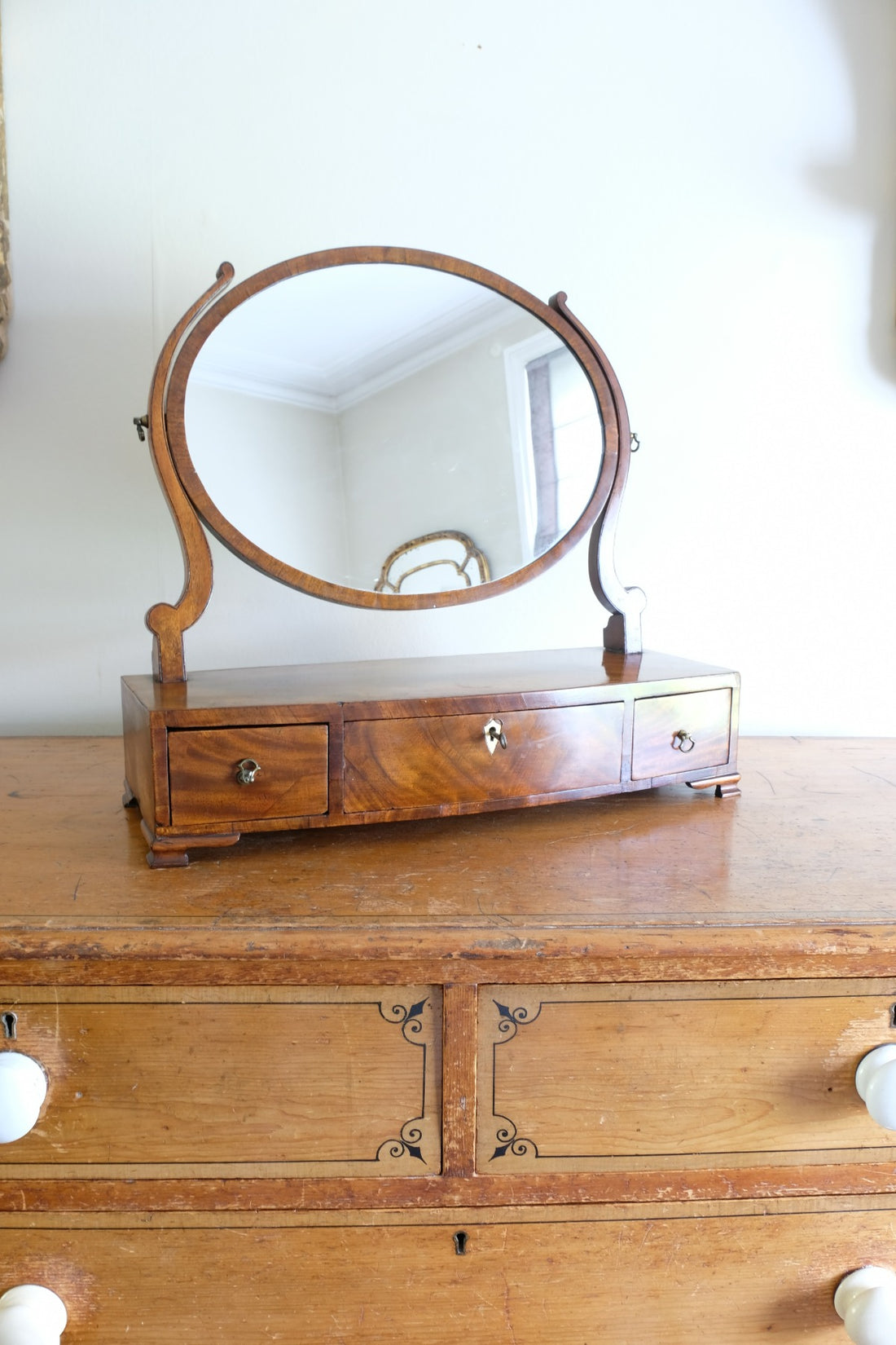 Flamed Mahogany Table Top Oval Mirror With Three Bow Fronted Drawers