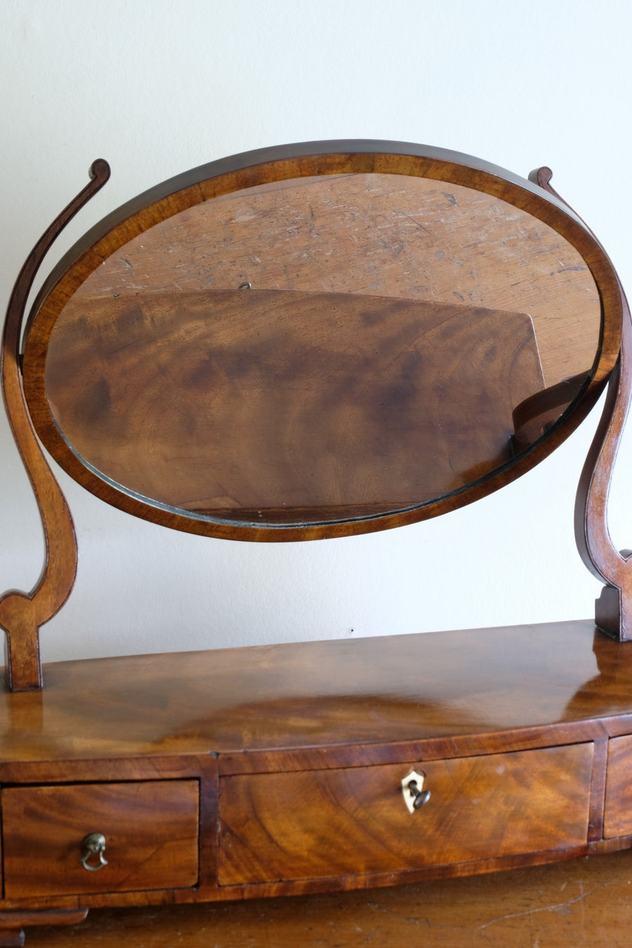 Flamed Mahogany Table Top Oval Mirror With Three Bow Fronted Drawers