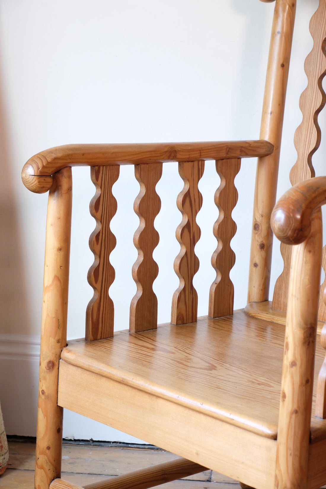 Hand‑curl armrest of pitch pine bobbin armchair