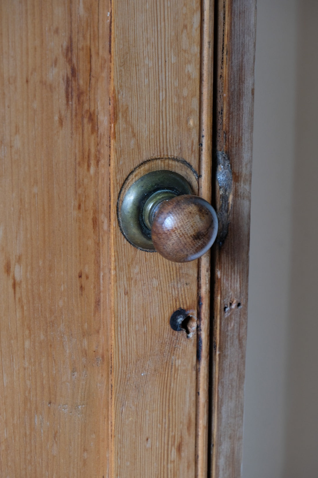 Close up brass latch on Victorian pine cupboard