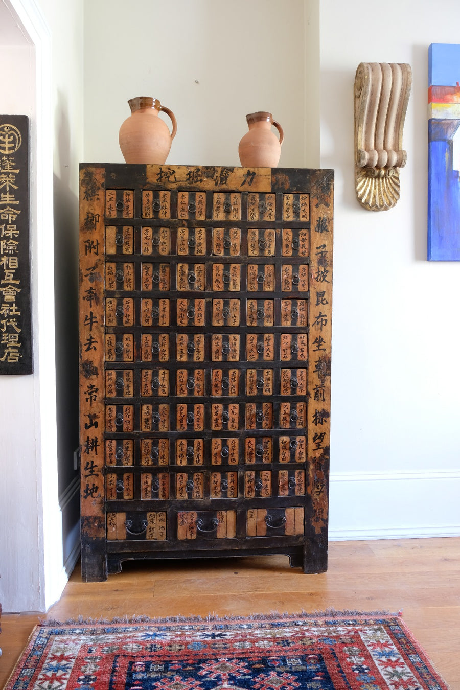 Painted Chinese bank of 57 drawers with hand-painted calligraphy