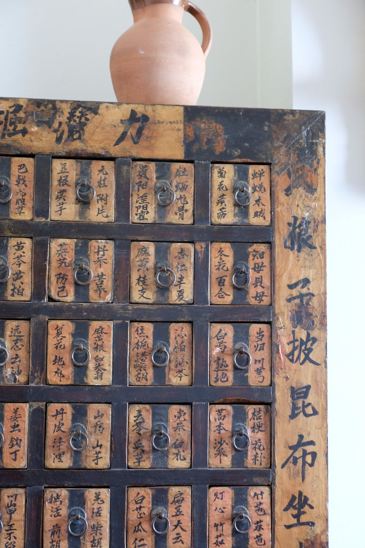 Painted Chinese bank of 57 drawers with hand-painted calligraphy