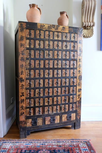 Painted Chinese bank of 57 drawers with hand-painted calligraphy