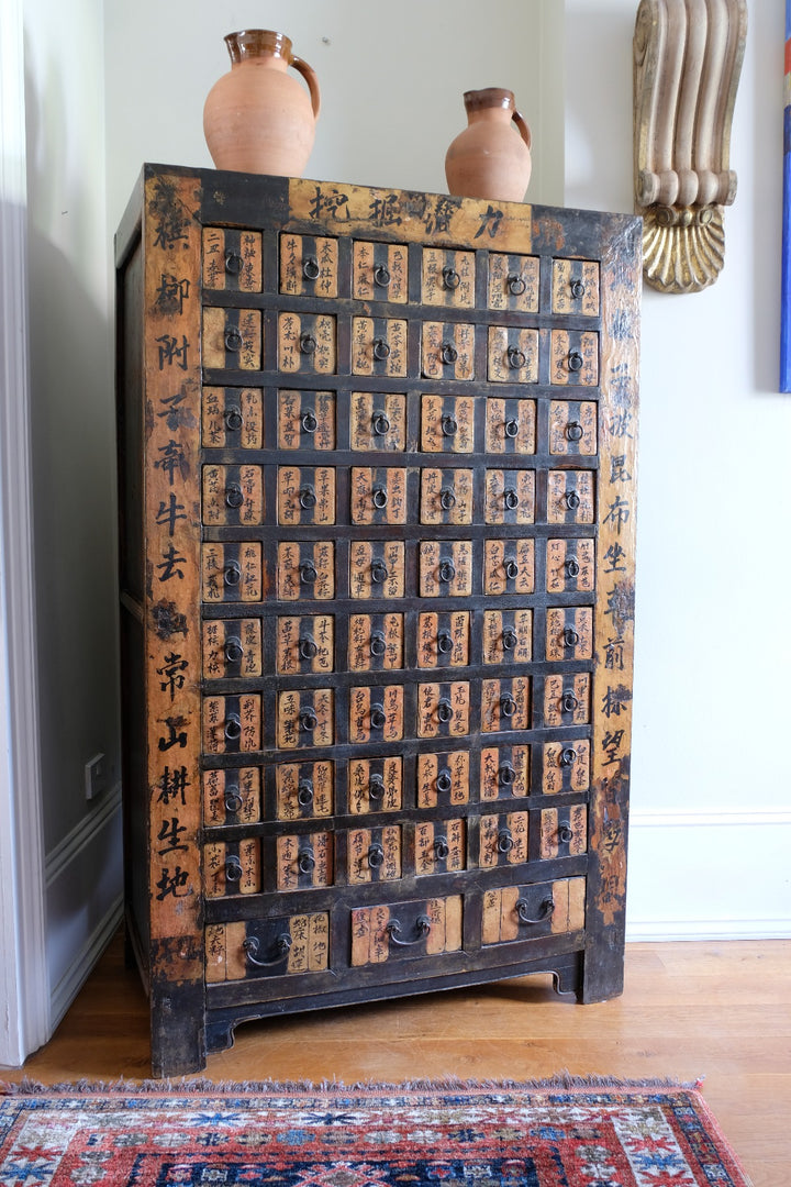 Painted Chinese bank of 57 drawers with hand-painted calligraphy