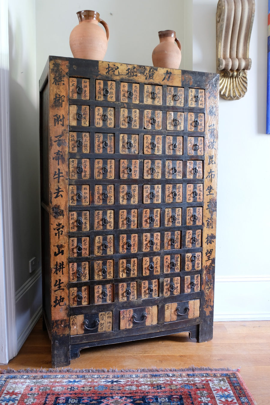 Painted Chinese bank of 57 drawers with hand-painted calligraphy