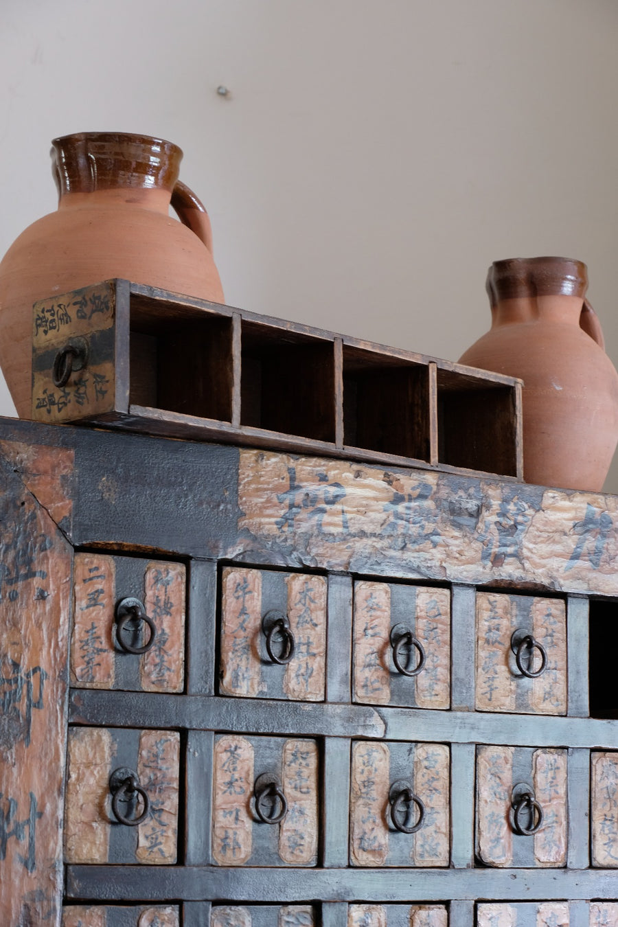 Antique Chinese storage cabinet in rustic layered orange and brown paint