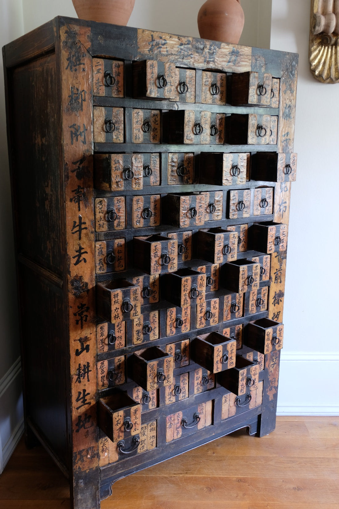 Antique Chinese storage cabinet in rustic layered orange and brown paint