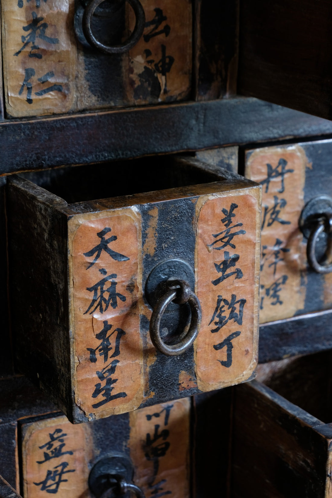 Primitive iron drop-ring pulls on Chinese antique storage drawers