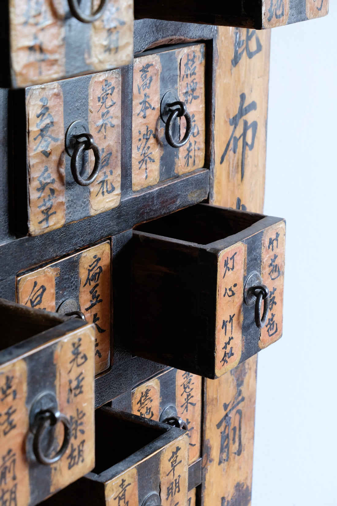 Primitive iron drop-ring pulls on Chinese antique storage drawers