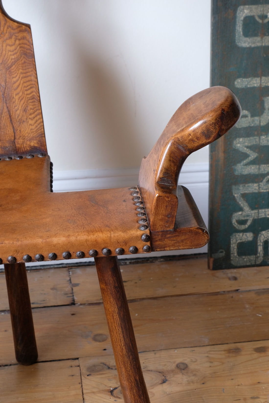 Detail of aged studded leather seat and patina