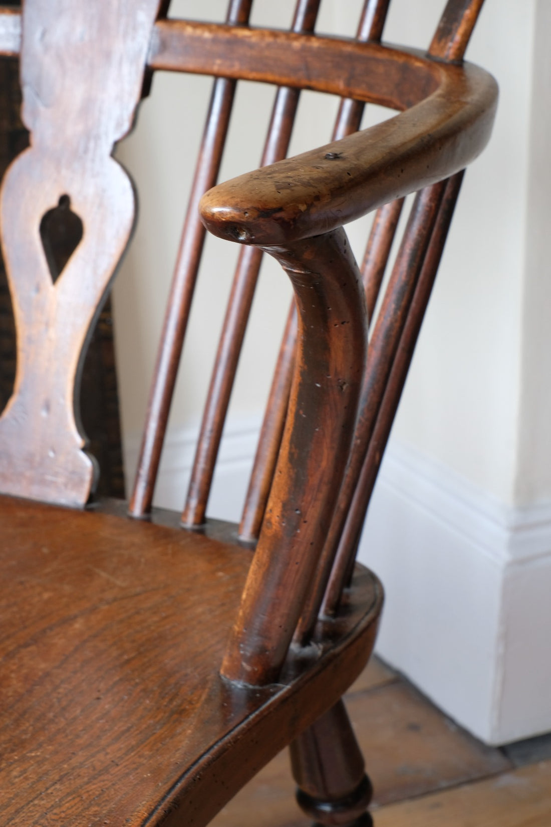 sweptback arms of a 19th Century Windsor Wheelback Armchair in Ash & Elm