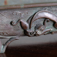 Close-up of dragon and cloud relief on Meiji Japanese bronze suiban vessel