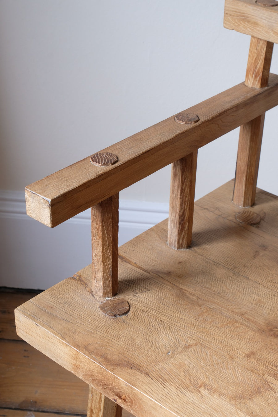 Close up armrest - Primitive handmade wooden armchair with rustic timber finish and blocky carved design