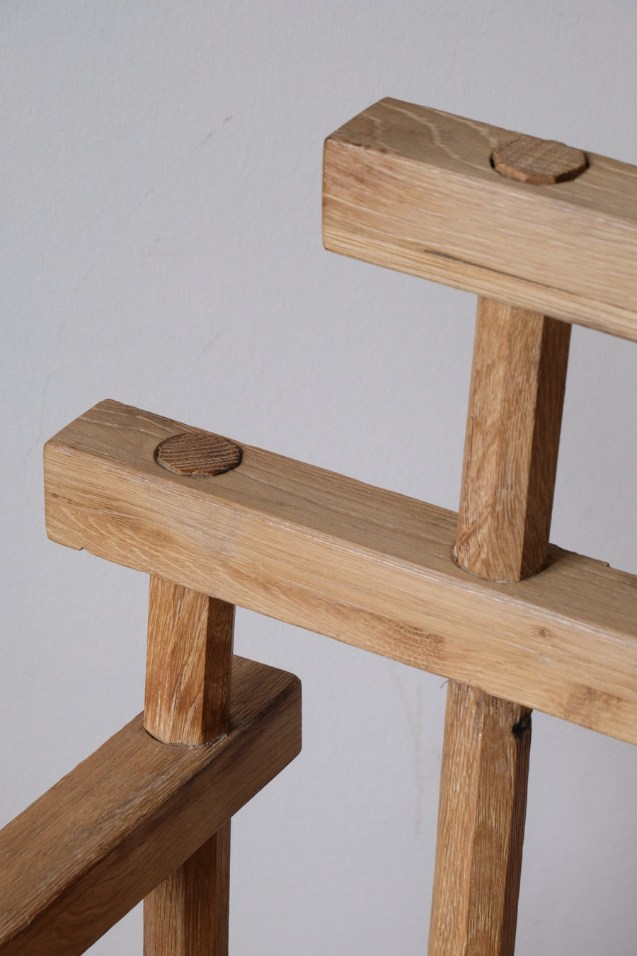 Close up back - Primitive handmade wooden armchair with rustic timber finish and blocky carved design