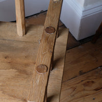 Primitive handmade wooden armchair with rustic timber finish and blocky carved design