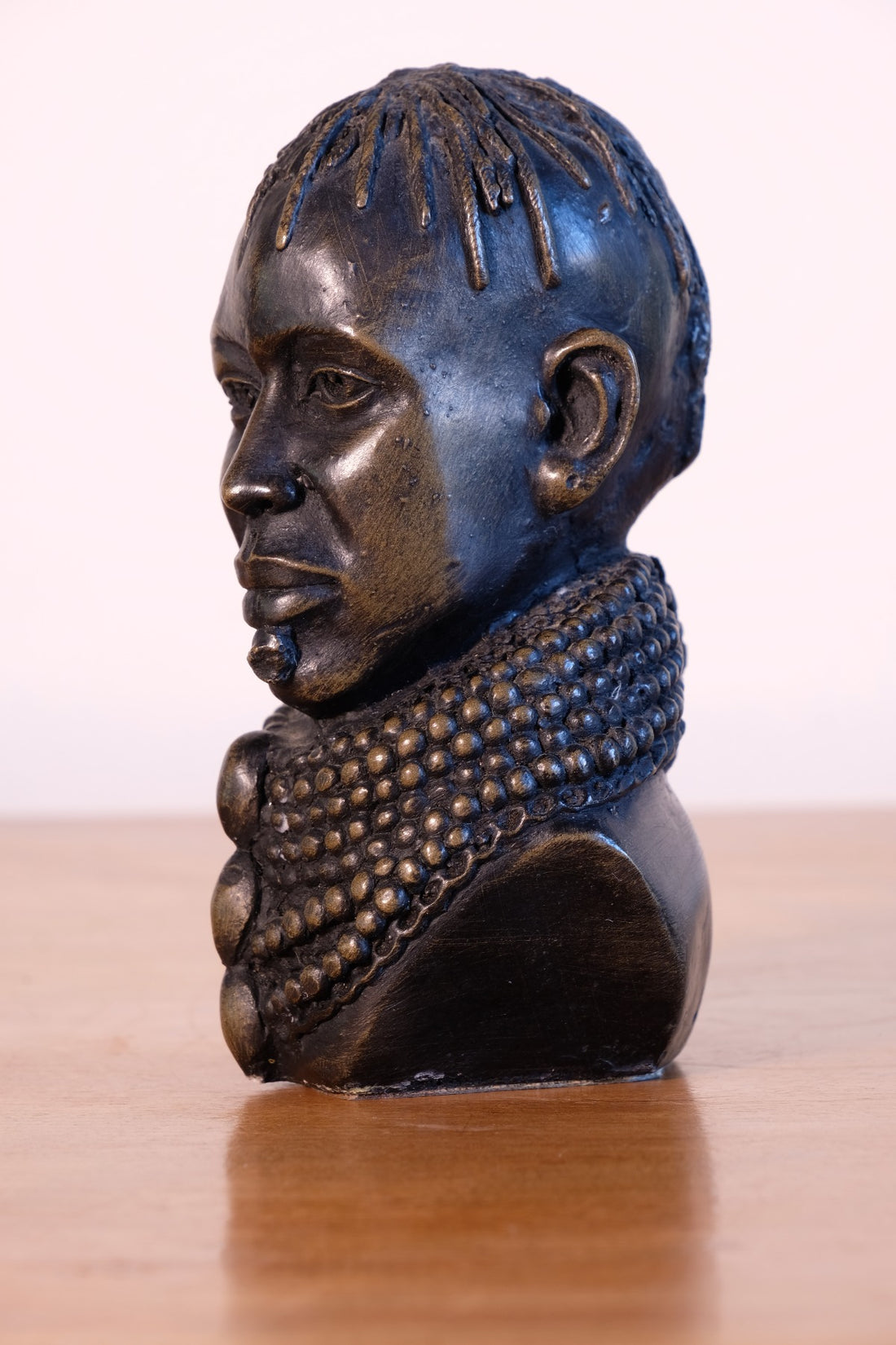 sculpture with textured beaded neck adornment