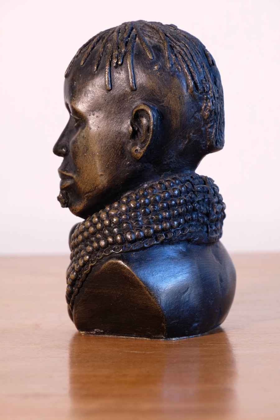 sculpture with textured beaded neck adornment