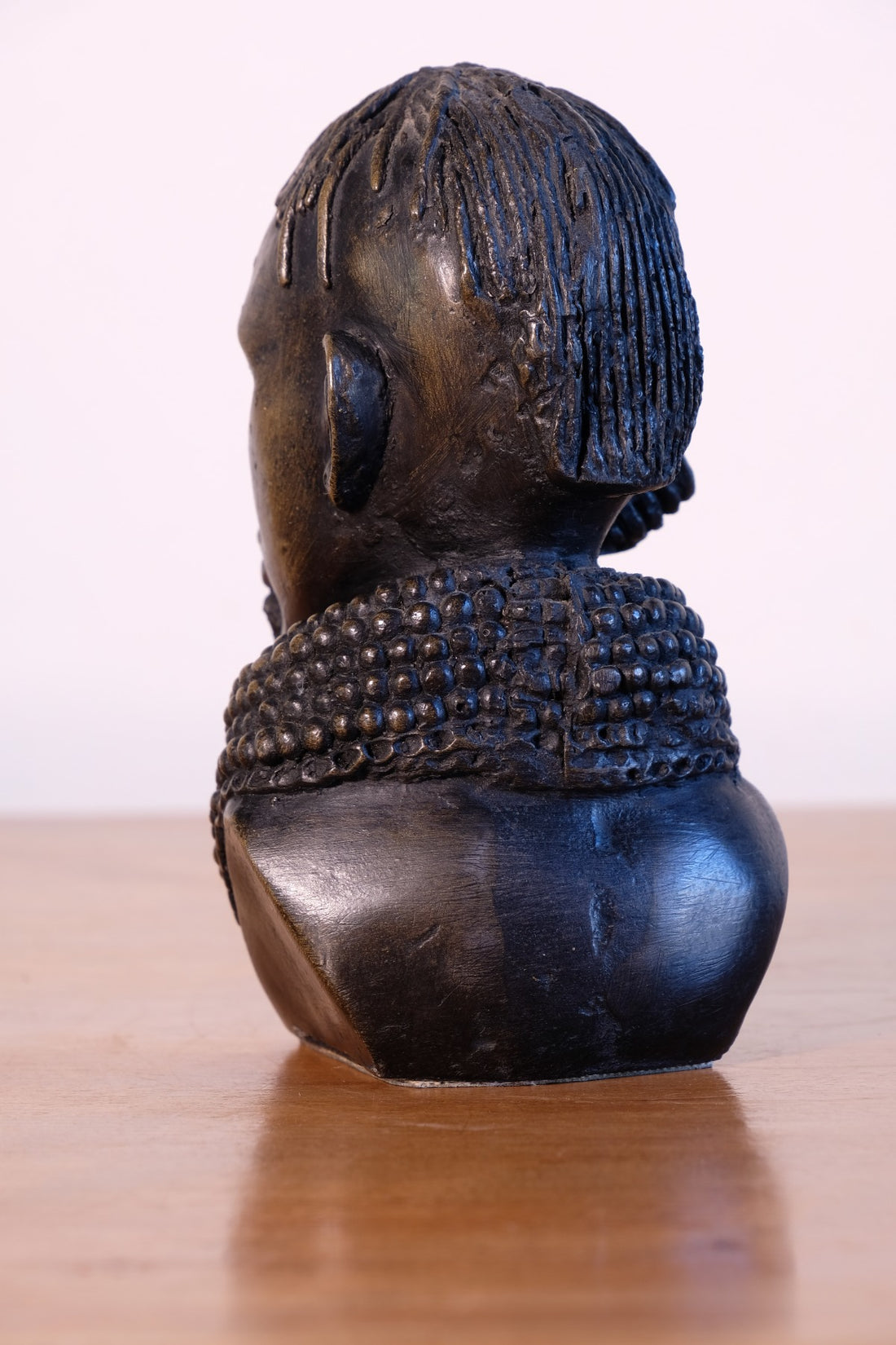 sculpture with textured beaded neck adornment