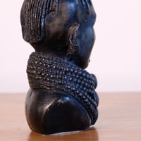 sculpture with textured beaded neck adornment