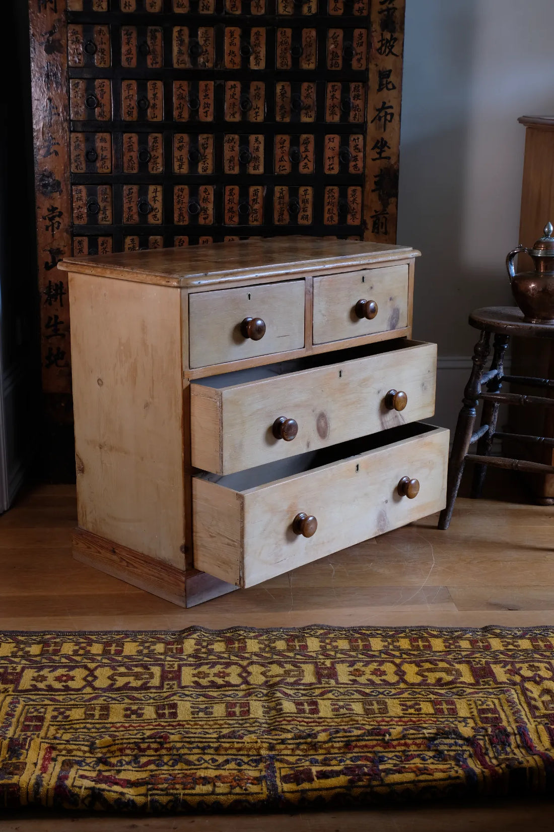 Bottom two drawers open on a Victorian Pine Chest of Drawers – Two Small Over Two Deep
