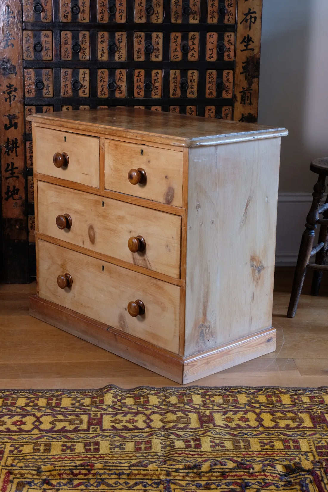 Angled view of a side view on a Victorian Pine Chest of Drawers – Two Small Over Two Deep