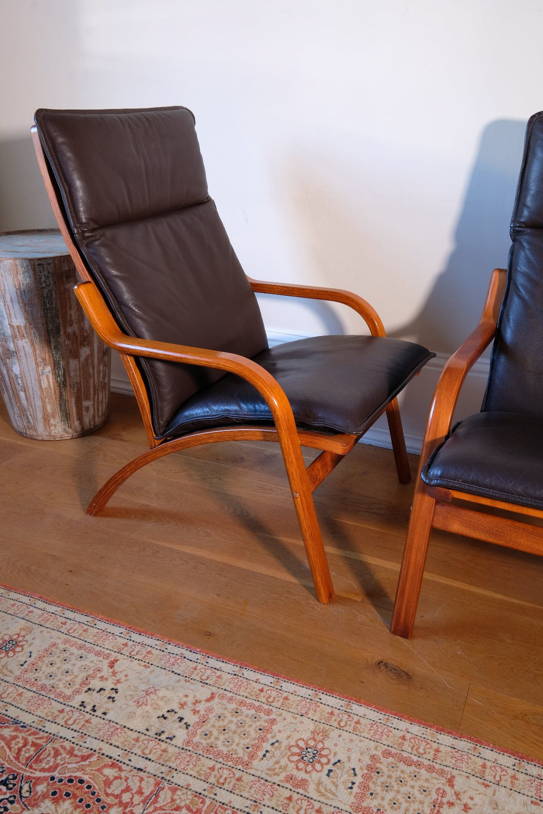 curved arm of a Pair of 1970s Danish Stouby bentwood leather lounge chairs with sculptural oak frame