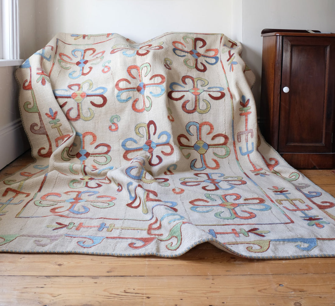 Vintage Uzbek Suzani kilim rug with embroidered floral medallions and vine scroll border, 173 x 230cm