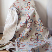 Vintage Uzbek Suzani kilim rug with embroidered floral medallions and vine scroll border, 173 x 230cm