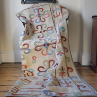 Vintage Uzbek Suzani kilim rug with embroidered floral medallions and vine scroll border, 173 x 230cm