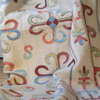 Vintage Uzbek Suzani kilim rug with embroidered floral medallions and vine scroll border, 173 x 230cm