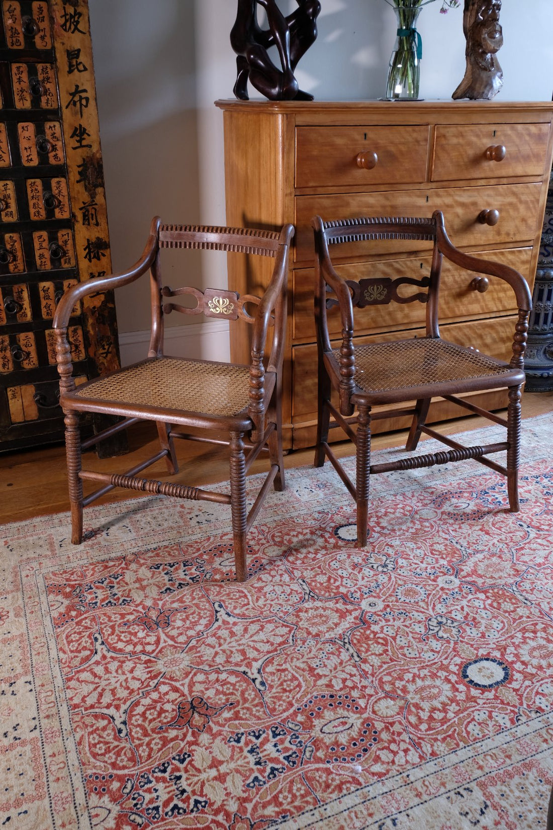 Pair of Regency mahogany armchairs with brass inlay and cane seats, circa 1810