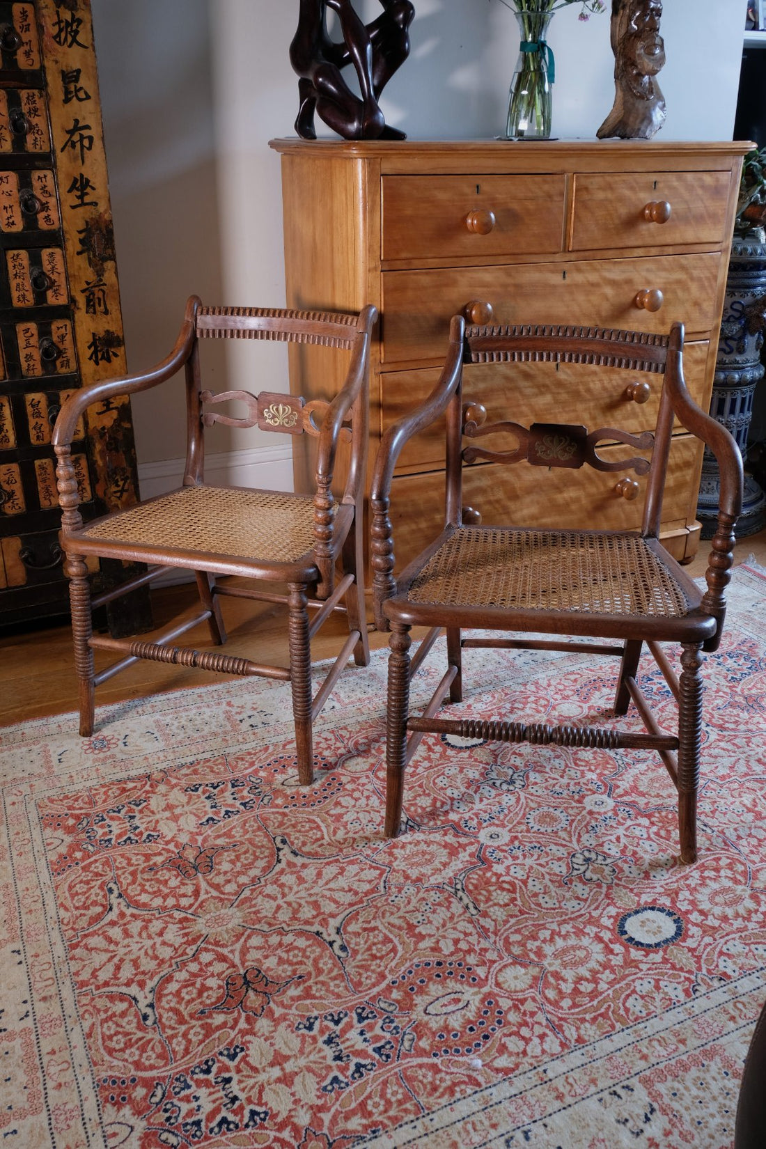 Pair of Regency mahogany armchairs with brass inlay and cane seats, circa 1810