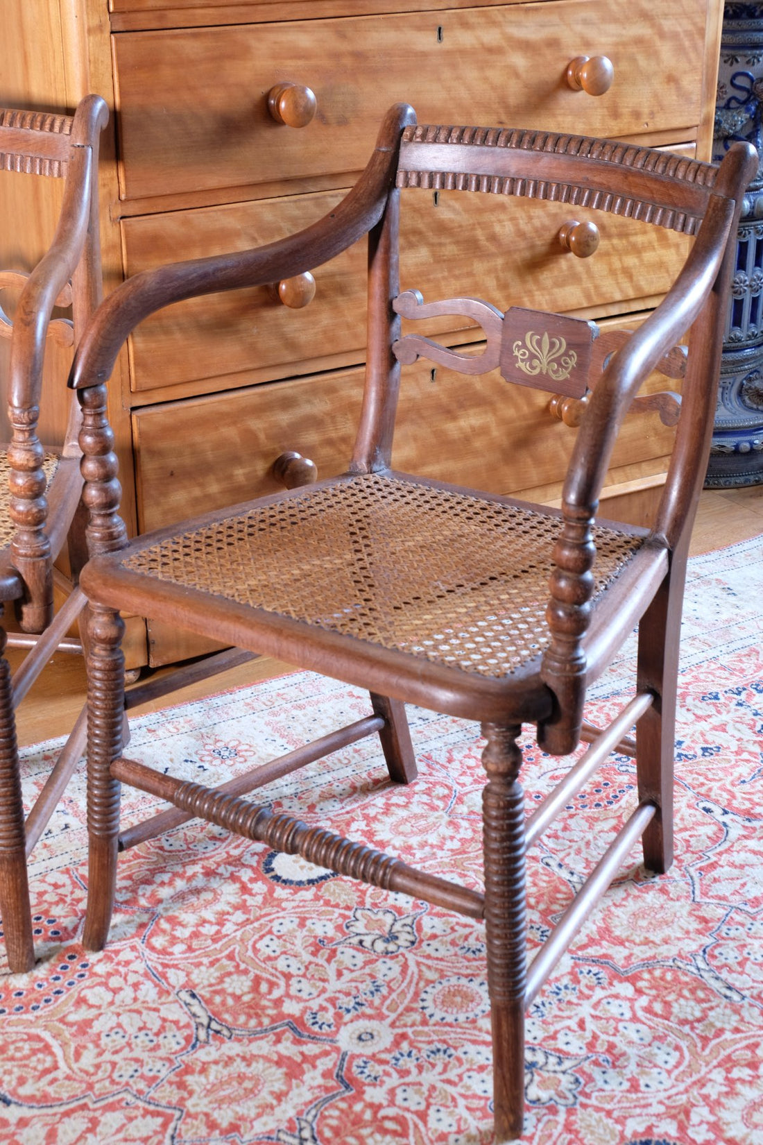 Pair of Regency mahogany armchairs with brass inlay and cane seats, circa 1810