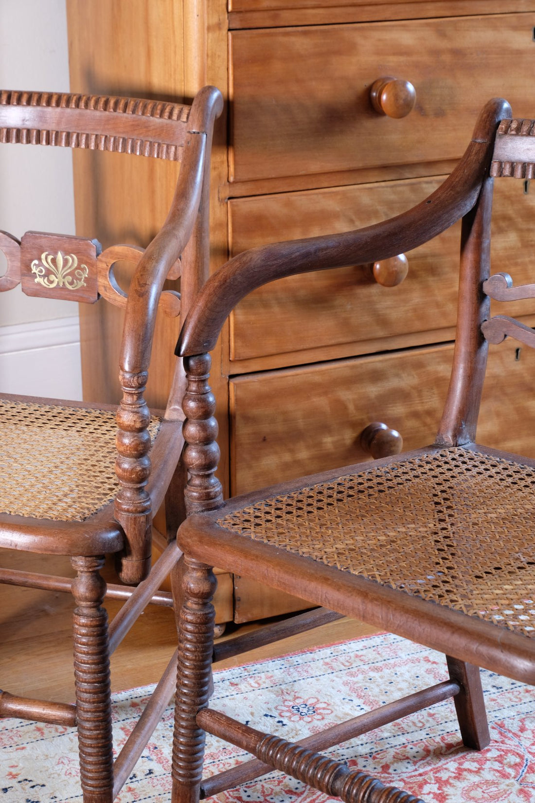 curved arms a Pair of Regency mahogany armchairs with brass inlay and cane seats, circa 1810