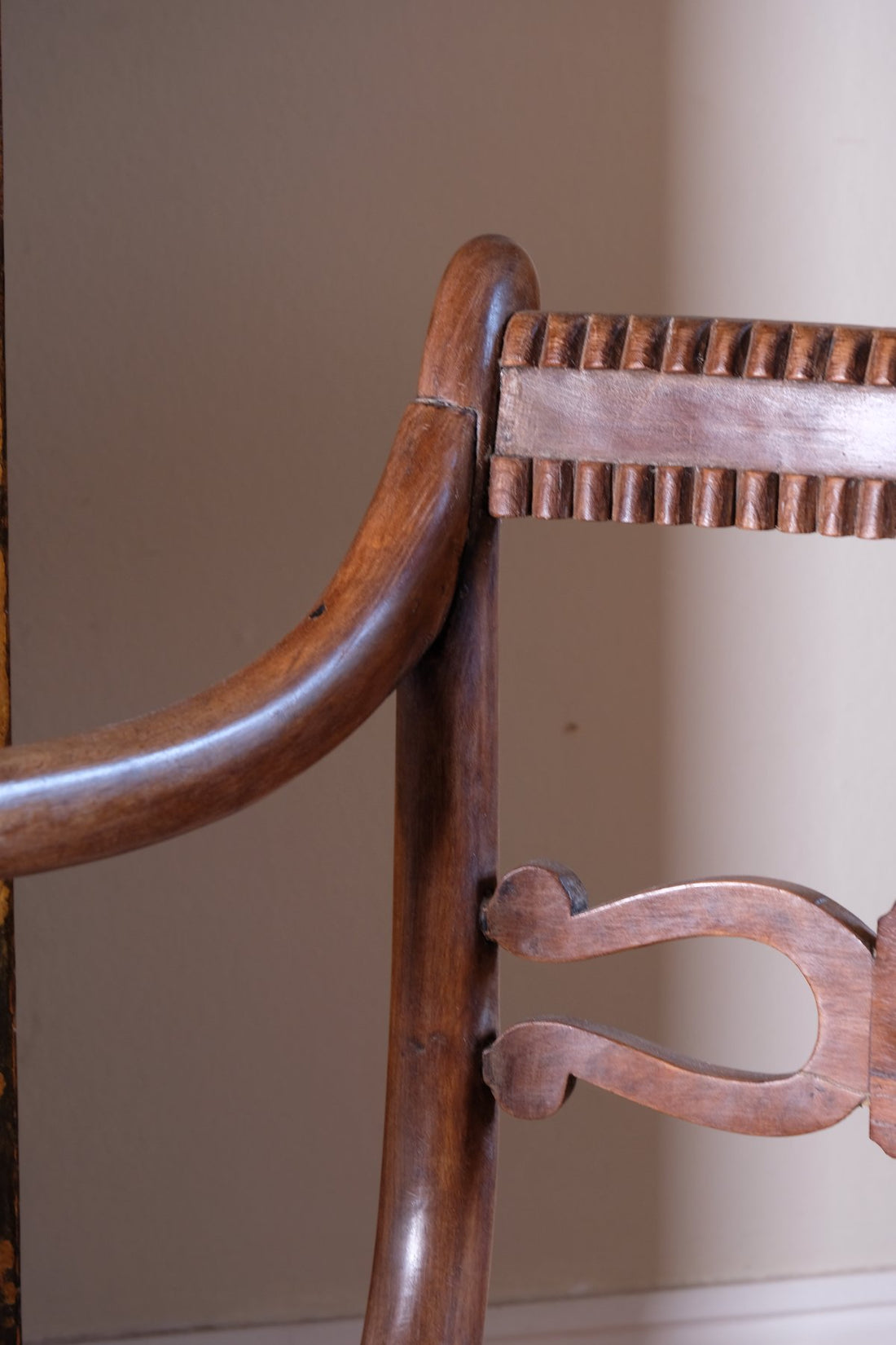 close up on a Pair of Regency mahogany armchairs with brass inlay and cane seats, circa 1810