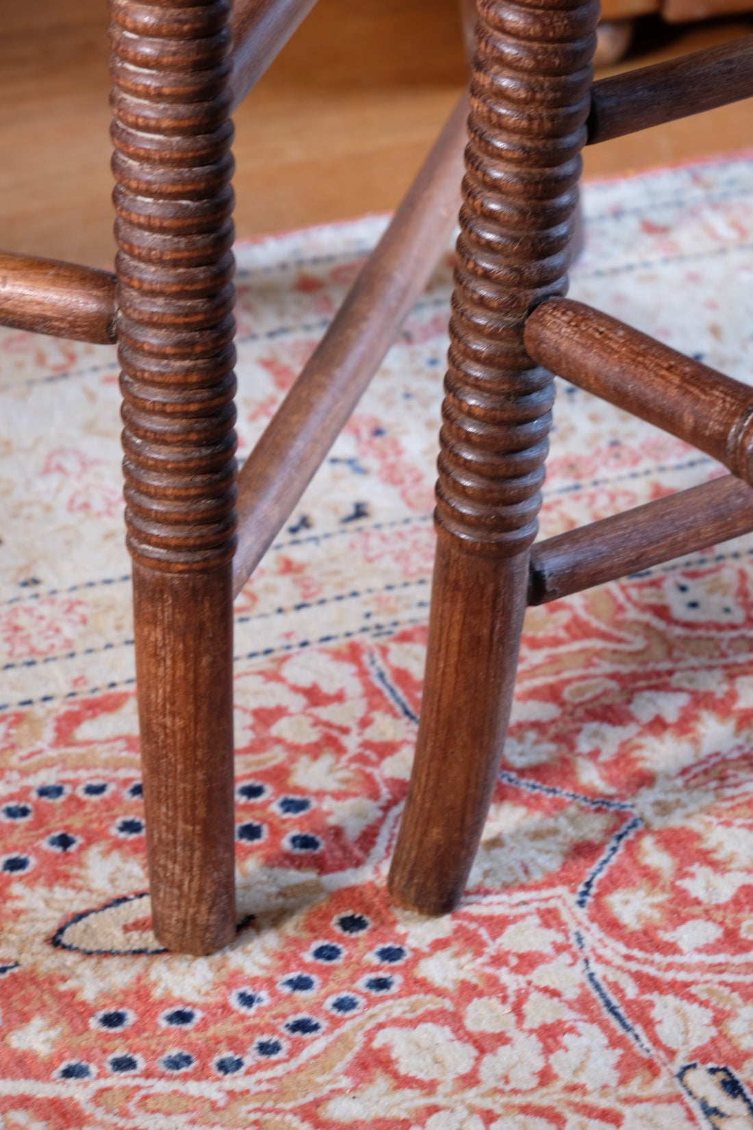 Bobbin legs on a Pair of Regency mahogany armchairs with brass inlay and cane seats, circa 1810