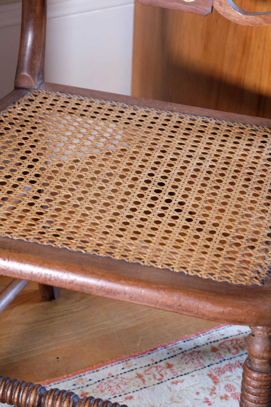cane seat on a Bobbin stretcher on a Pair of Regency mahogany armchairs with brass inlay and cane seats, circa 1810