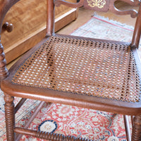 Bobbin stretcher on a Pair of Regency mahogany armchairs with brass inlay and cane seats, circa 1810