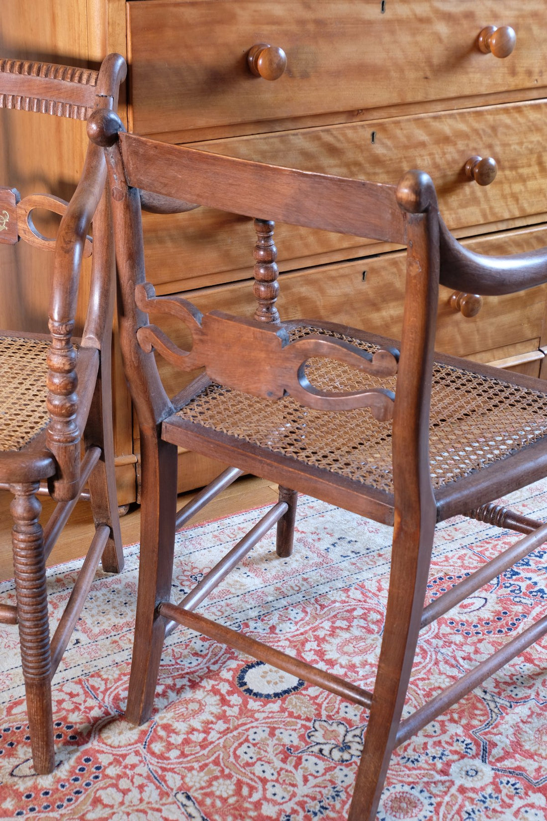 back view on a Pair of Regency mahogany armchairs with brass inlay and cane seats, circa 1810