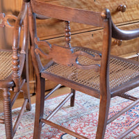back view on a Pair of Regency mahogany armchairs with brass inlay and cane seats, circa 1810